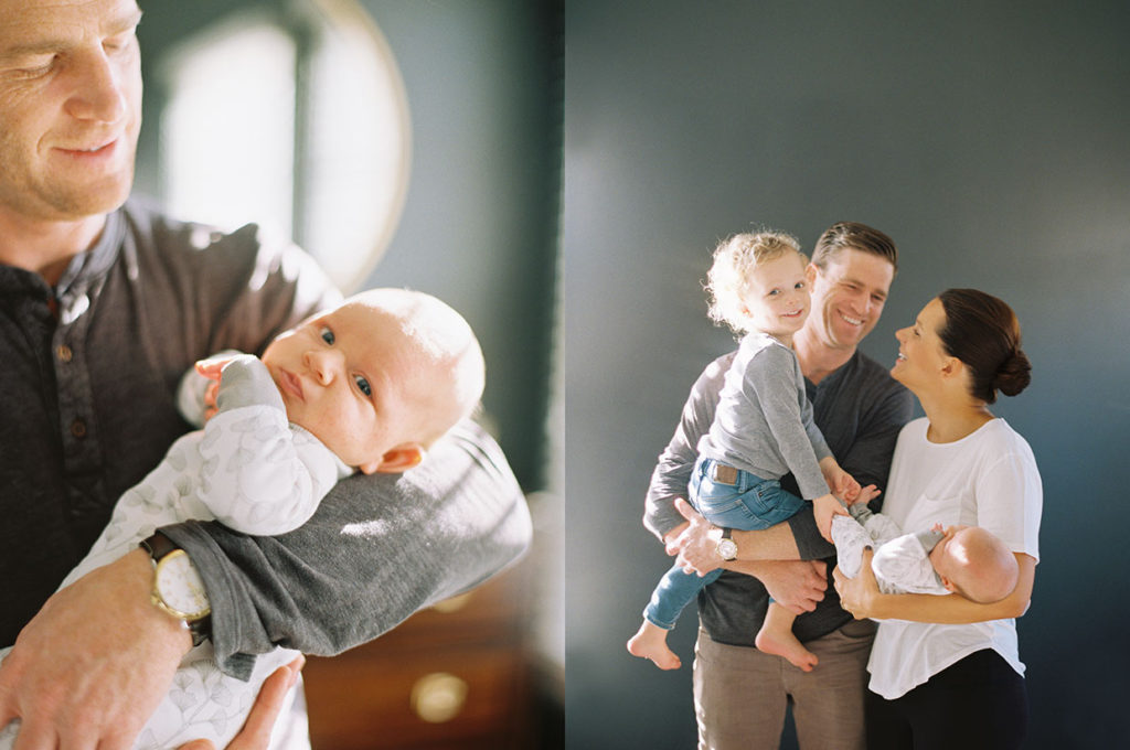 dad holding baby at newborn photography shoot